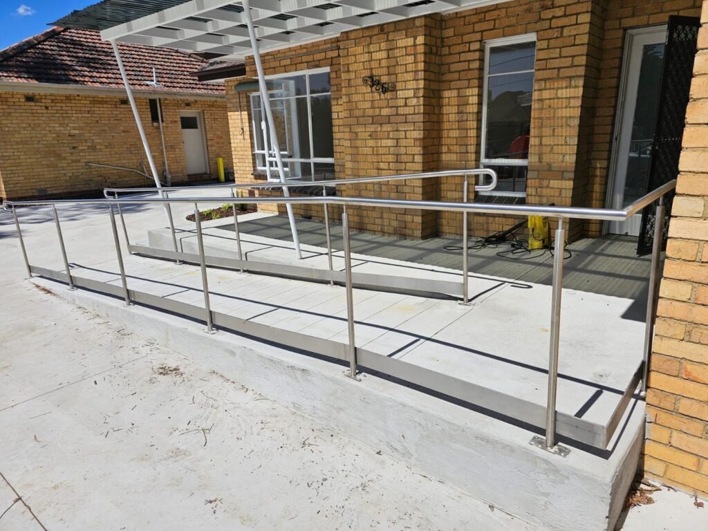 Installed tubular metal handrails along clinic entrance ramps