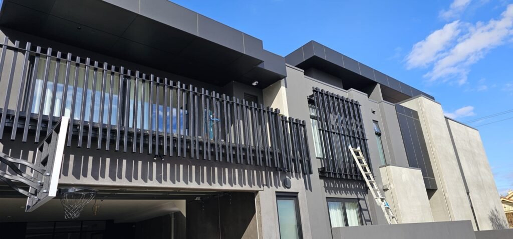 Installed balcony balustrades and vertical window screens on a Coburg home