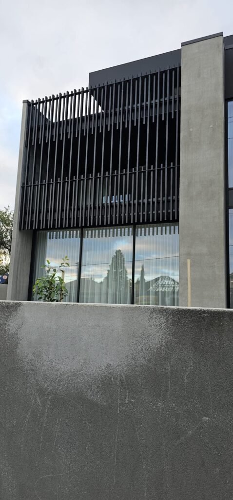 Installed dark vertical steel feature screen on a contemporary Coburg home